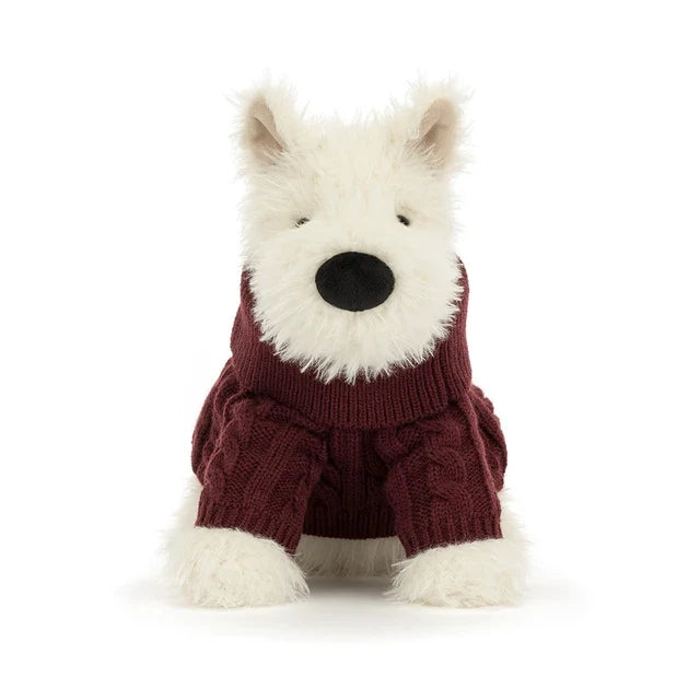 A plush jellycat West Highland terrier dog toy wearing a burgundy cable-knit sweater, set against a plain white background.