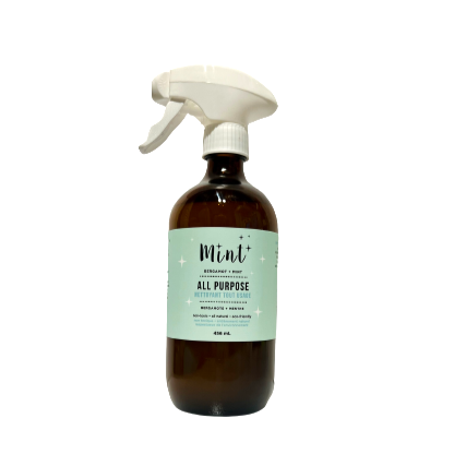 brown bottle of all purpose cleaning from mint cleaning with white sprayer and mint blue label. 