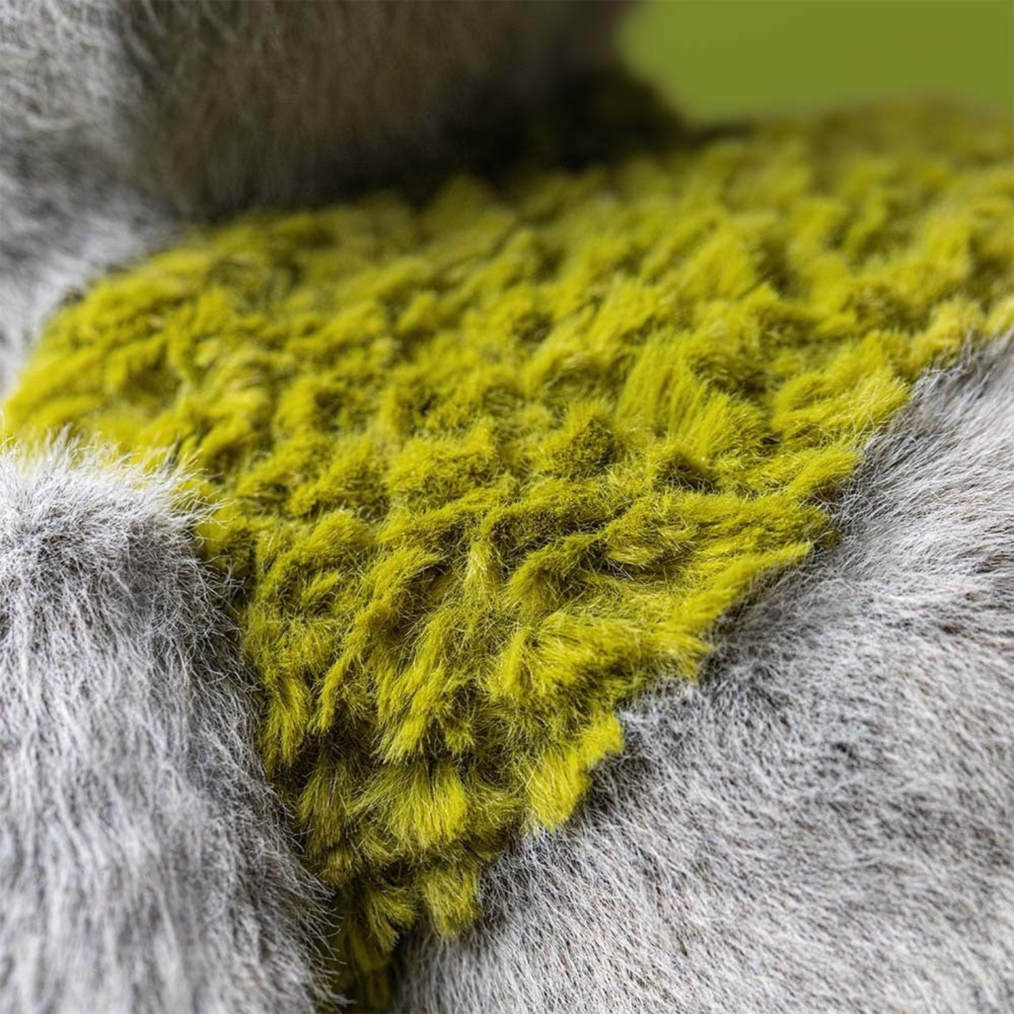 Close-up of a textured green fabric on a gray surface
