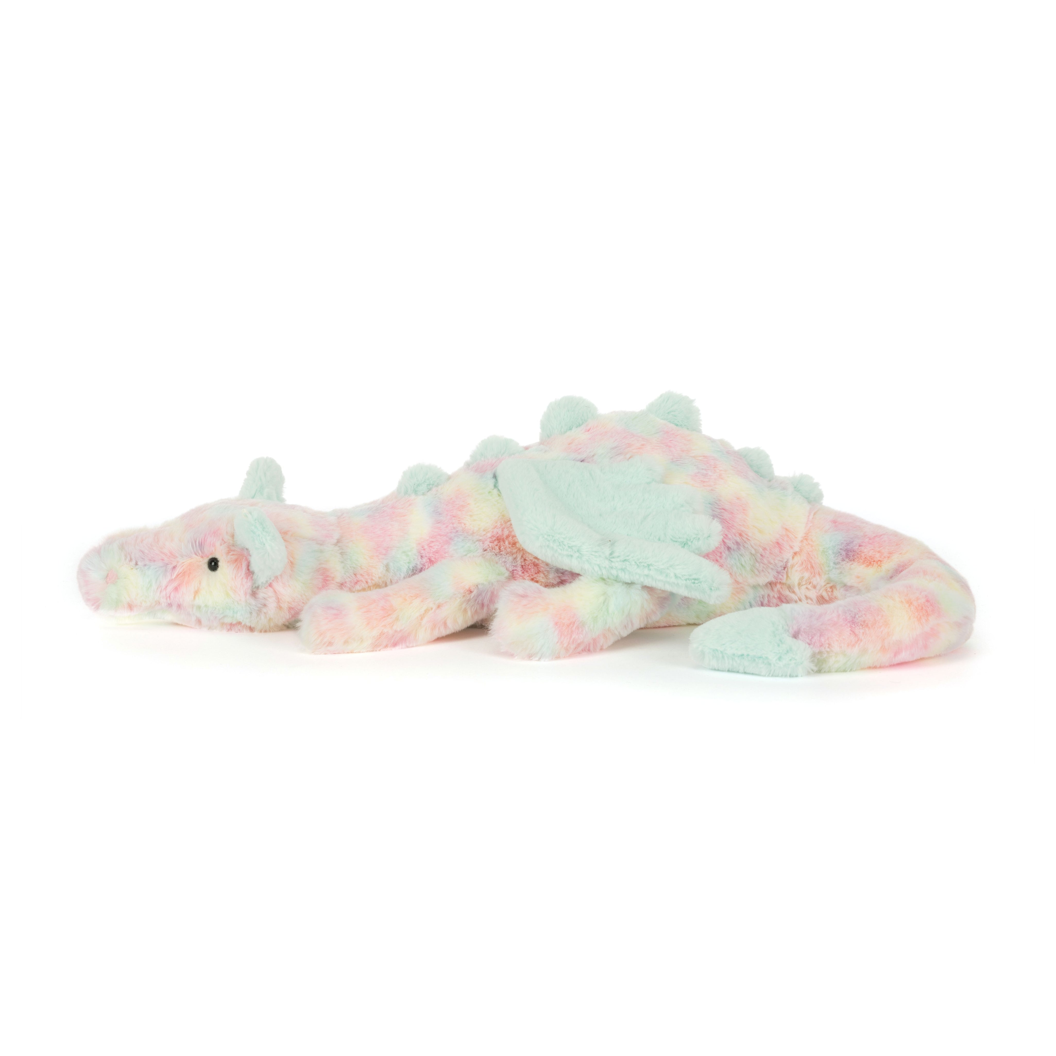 Plush dragon toy with pastel colors on a white background