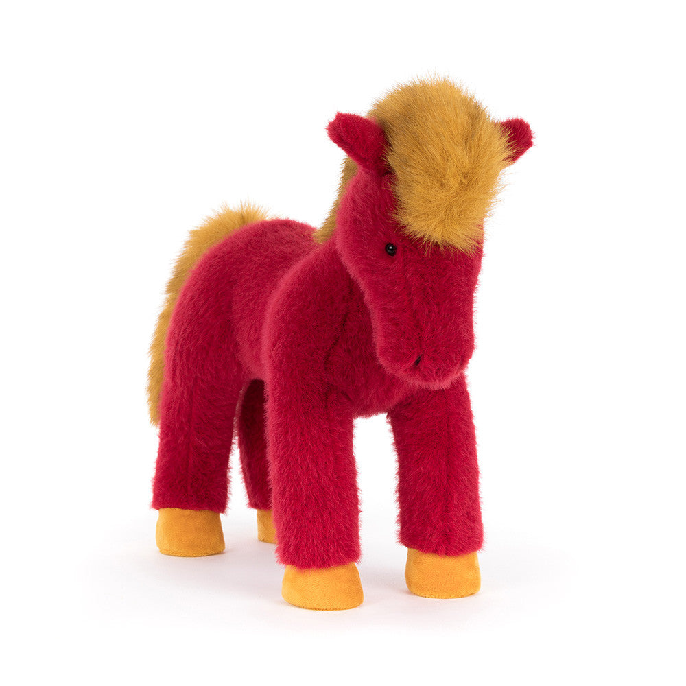 Plush toy horse with red body and golden mane  and tail and yellow hooves on a white background