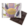 chocolate bar with white package with purple stipe and  lavender illustrations. square chocolate bar with sections with Rogers logo and cocoa beans on it. on white background 