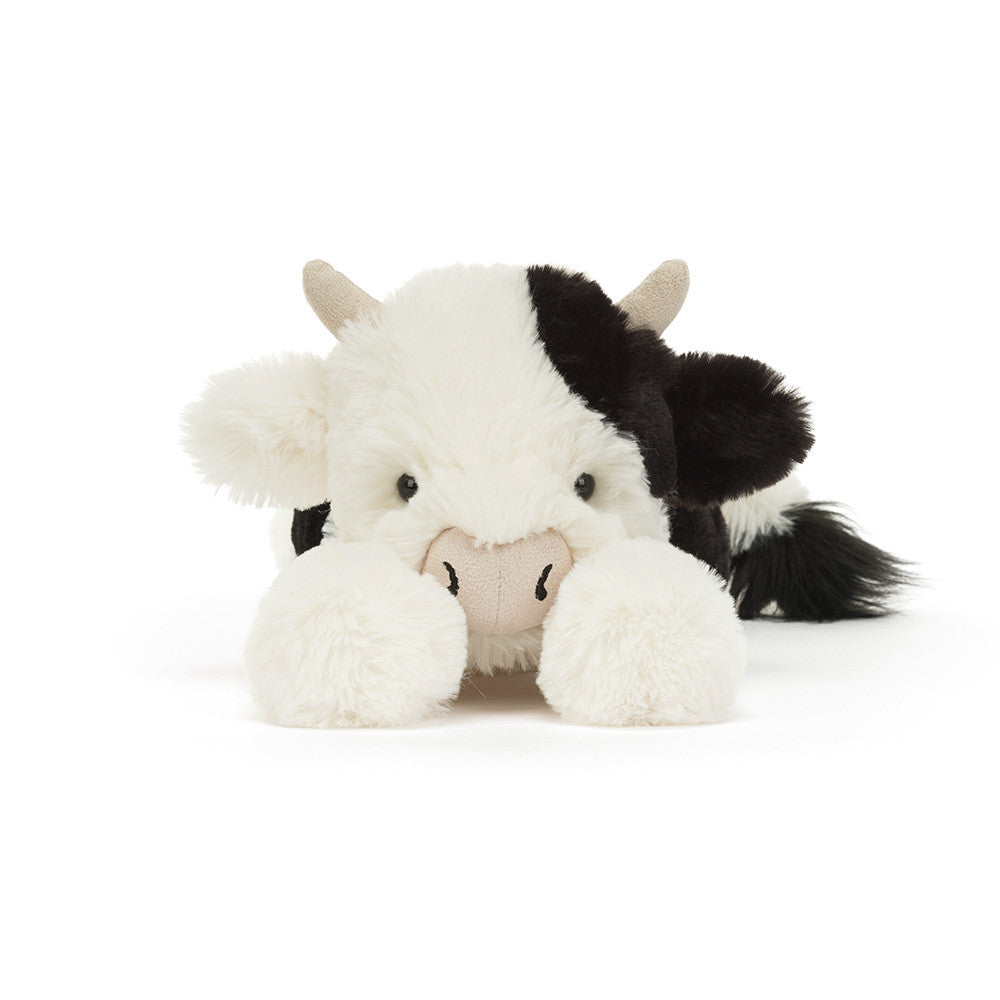 Plush cow toy with black and white pattern on a white background