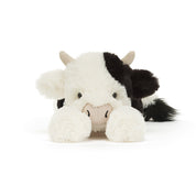 Plush cow toy with black and white pattern on a white background