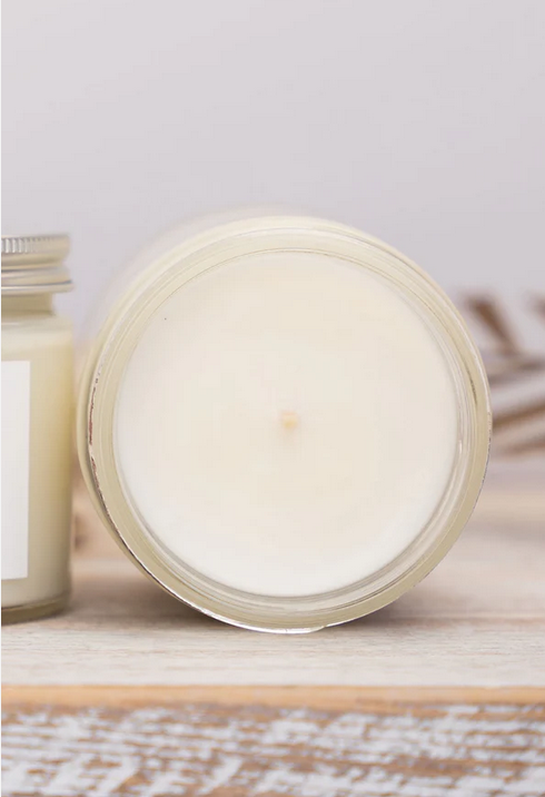 top of a candle on a wooden surface with a light background