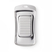 Metallic garlic grater on a white background