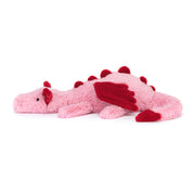 Pink plush dragon toy with red accents on a white background