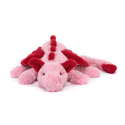 Pink and red plush dragon toy on a white background