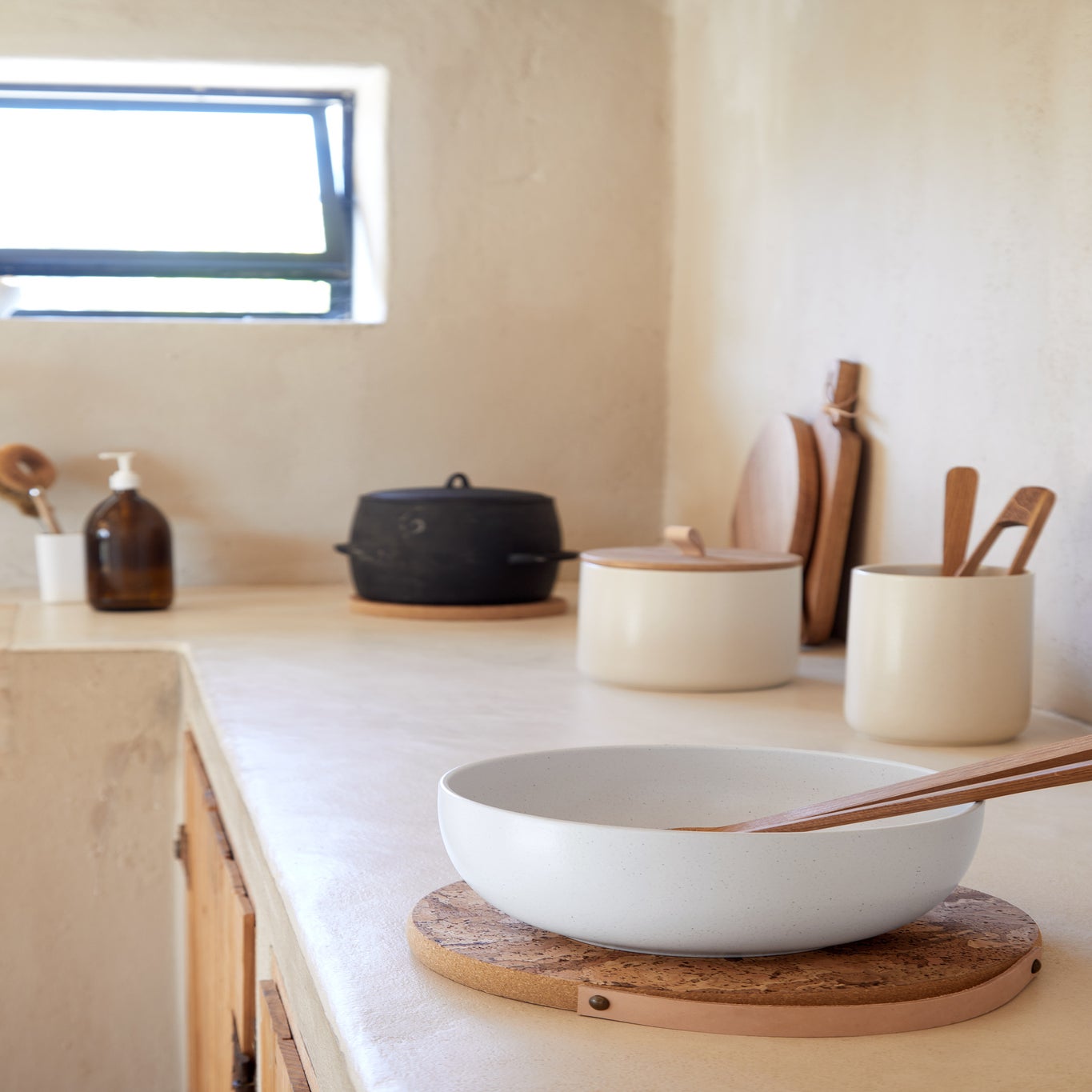 Kitchen counter with various ceramic items including bowls and a pot.
