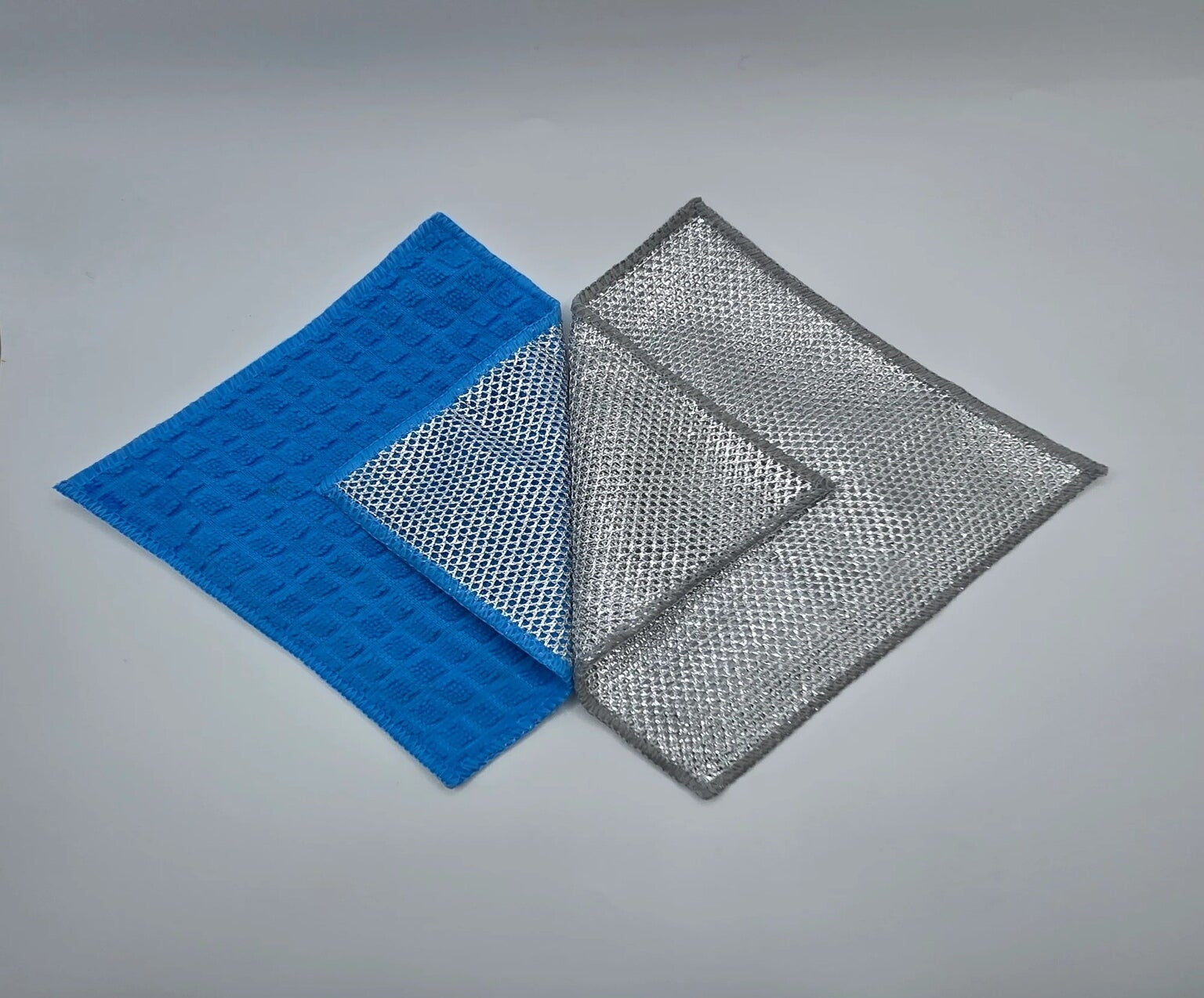 Blue and gray mesh jude's cleaning clothes on a gray background
