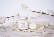Candle with a label on a white surface with decorative elements