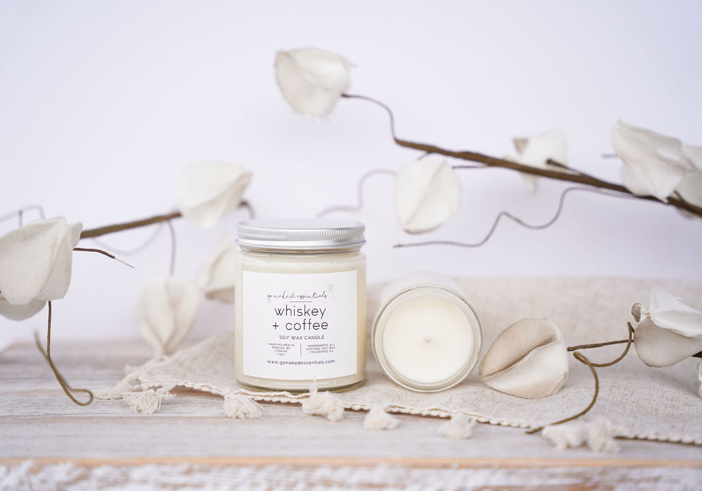 Candle with a label on a white surface with decorative elements
