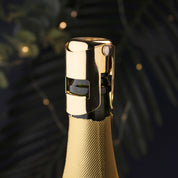 Gold bottle cap on a champagne bottle with a blurred background