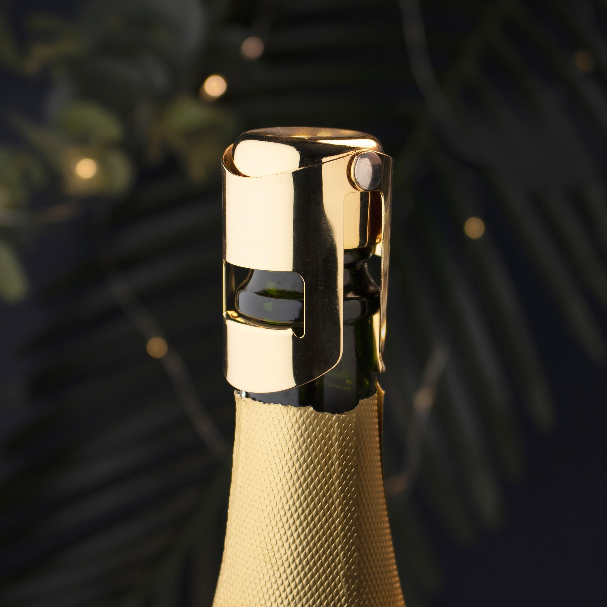 Gold bottle cap on a champagne bottle with a blurred background