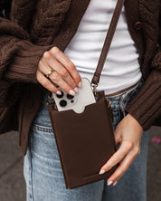 louenhide purse in chocolate on a person wearing a brown sweater