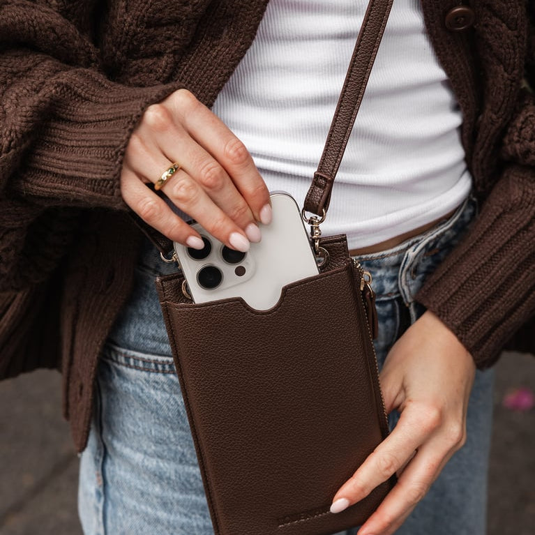 louenhide purse in chocolate on a person wearing a brown sweater