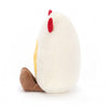 side view of white and yellow fried egg stuffed plush toy with red devil horn and black grinning face made by jellycat