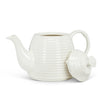 glossy white bone china teapot in shape of beehive with long curled spout. lid if off and propped against side. on white background
