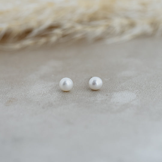 freshwater pearl earrings by glee on grey surface