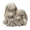 four different sized fluffy beige bashful bunnies stuffed plush toys made by jellycat