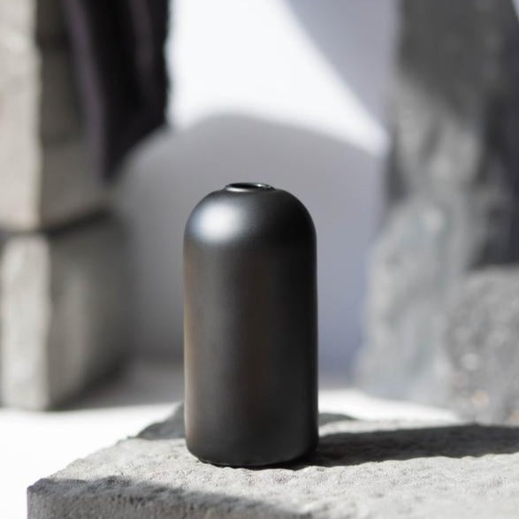 black wylie vase by everlasting candle co on stone background