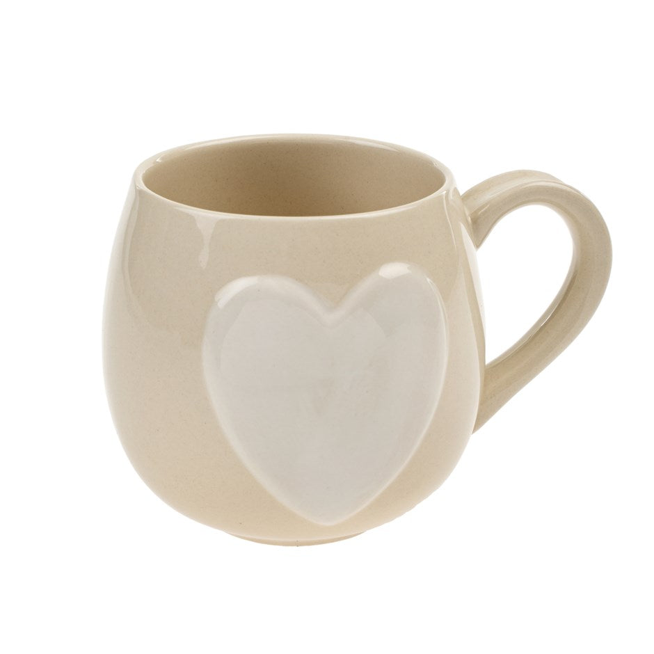 rounded beige mug with big white heart in middle made by indaba