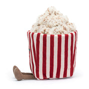 side view jellycat plush toy red white stripe popcorn bag with face and brown legs on white background 