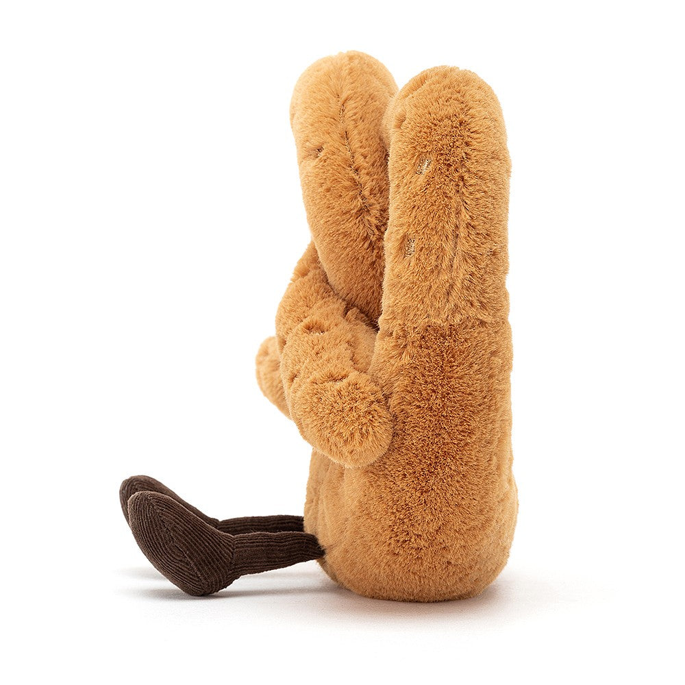 side view of fuzzy soft brown stuffed plush toy pretzel made by jellycat