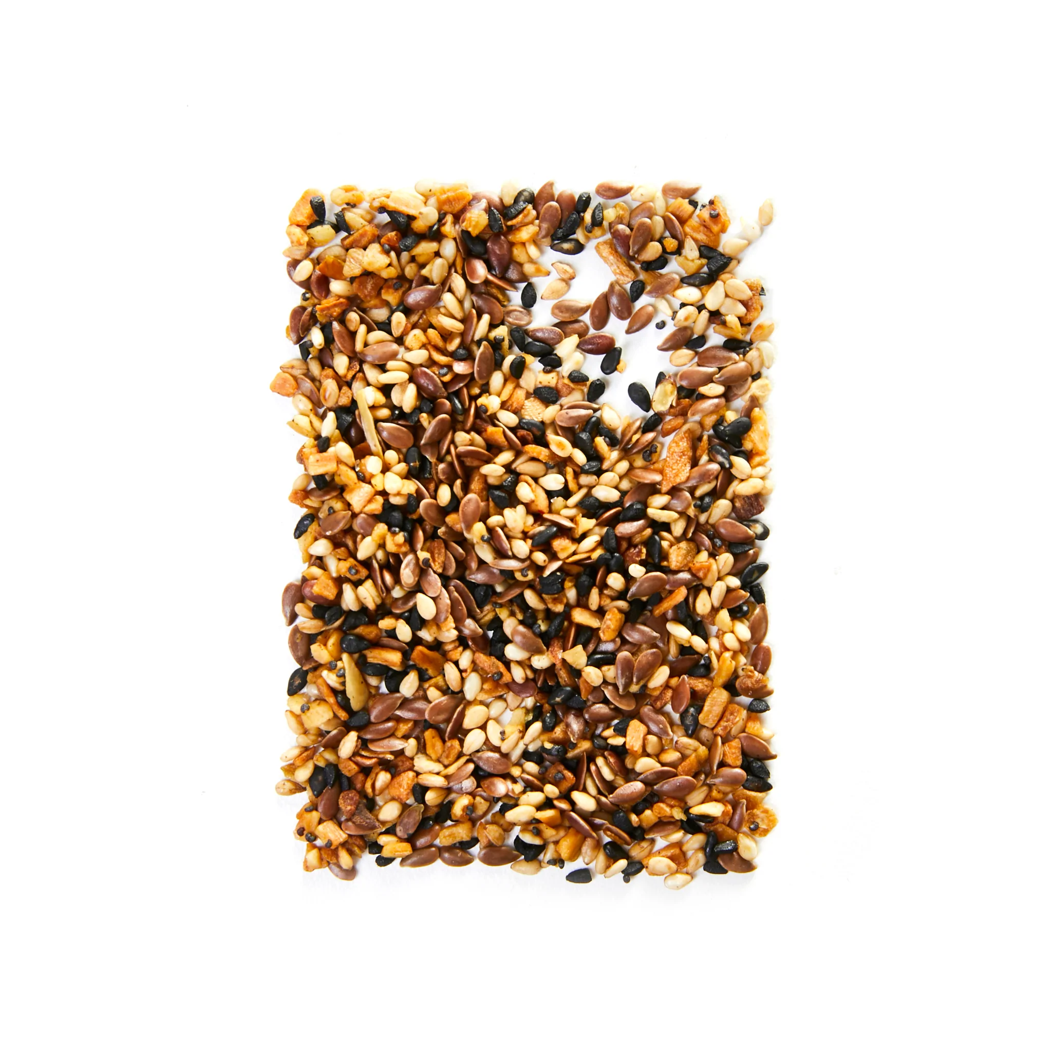 piles of montreal bagel spice shaped into a rectangle on a white background