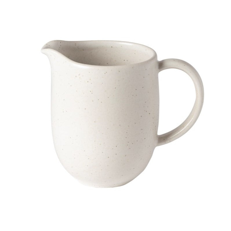 off white speckled stoneware pitcher on white background