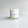 rainforest candle  clear glass jar wood wick white label on white marble table